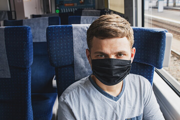 Young man wearing protective face mask sitting in the traing