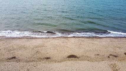 Aerial View of the Coastline with waves colliding with the beach
