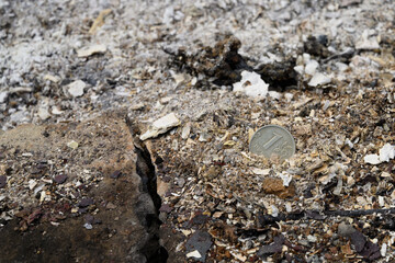 Russian coin lie among on red-hot ashes. Russian currency devaluated, finance and business concept