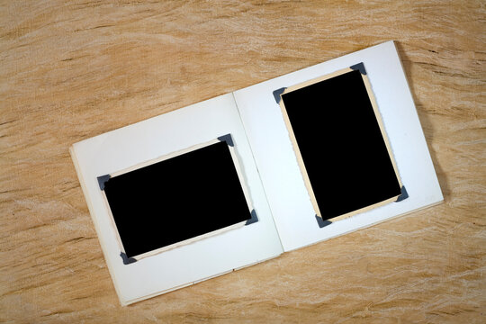 Opened book with empty picture frames, flat lay, mock up, copy space