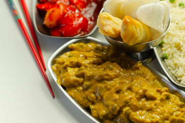 Chinese set,  chicken curry, sweet and sour chicken served with egg fried rice, vegetable spring rolls, and prawn crackers