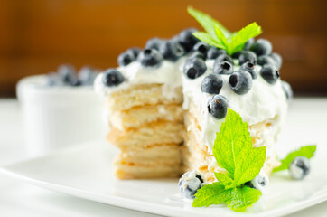 Delicious pancakes with sweet creamy yogurt and fresh berries with mint