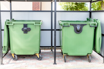 large green garbage containers in a special place