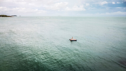 people on a lonely raft in the sea. castaway people need help.