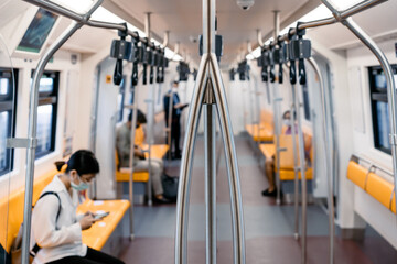 The local Thai people transports inside the train of Bangkok (Mass) Transit System on the midday...