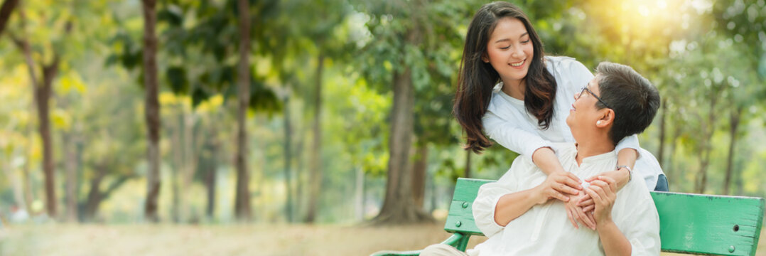 Mother And Daughter Hug And Smiled Together On Chair In Garden, Concept Of Mother Day And Happiness Family