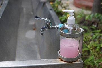 close-up bottle of hand soap placed at the sink
