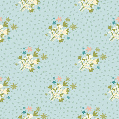 Naive seamless pattern with green and white abstract floral ornament. Blue background with dots.