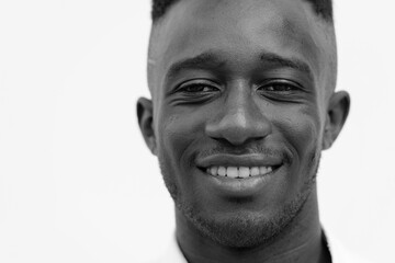 Young African businessman in the city outdoors in black and white