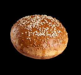 baked round bun with sesame seeds isolated on black background