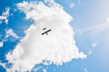 A plane is flying in the peaceful sky. Part of a modern military hardware. A military parade rehearsal. A plane is performing a display of aerobatics.