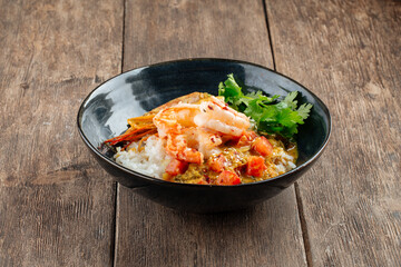 Asian dish curry with langoustines and hikari rice
