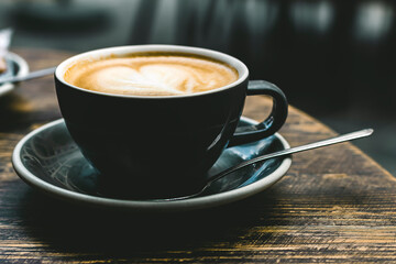 Selective focus of cup of coffee cappuccino with foam heart