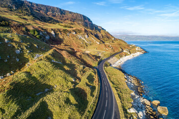 The eastern coast of Northern Ireland and Causeway Coastal Route a.k.a Antrim Coast Road A2. One of the most scenic coastal roads in Europe. Aerial view in winter - 369721428