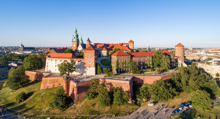 Royal Wawel Cathedral and castle in Krakow, Poland. Aerial view in sunset light in summer with a park,  promenade and  walking people © nahlik