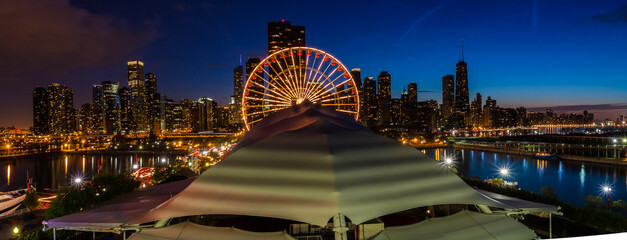 Fototapeta premium Amusement Park and Downtown Skyline at Night, Chicago, Illinois, USA