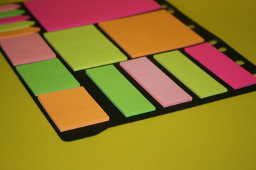 set of colorful stickers for notes on a yellow background