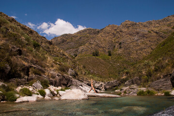 Yoga pose on a lake shore
