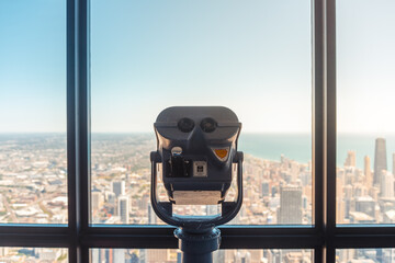coin-operated binocular on top of the building looking into the city