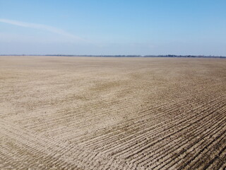 Agricultural fields on a sunny spring day, aerial view. Landscape. Blue sky over the fields.