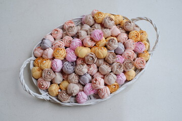 Artificial flowers made out of fabric in beautiful pastel color. This handmade flower can be used as decoration on headband, dress, and many other as craft supply material.