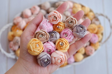 Artificial flowers made out of fabric in beautiful pastel color. This handmade flower can be used as decoration on headband, dress, and many other as craft supply material.
