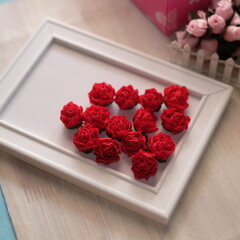 Artificial flowers made out of fabric in beautiful pastel  red color. This handmade flower can be used as decoration on headband, dress, and many other as craft supply material.