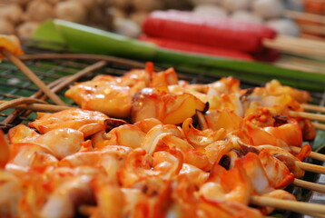 Grilled squid skewers and street food in Thailand.