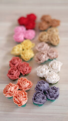 Obraz na płótnie Canvas Artificial flowers made out of fabric in beautiful pastel color. This handmade flower can be used as decoration on headband, dress, and many other as craft supply material.