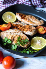 Assortment of Chicken steaks with condiments