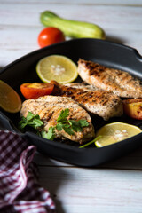 Pan fried meat with vegetables and ingredients and condiments in a pan with use of selective focus