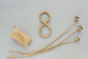 Dried flowers, gift box made of kraft paper, number eight of jute handmade on grey background. Greeting card. international women's day. ecology, handmade, romance, valentines day and holidays concept