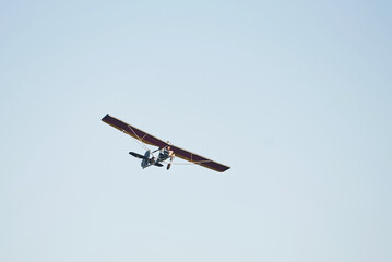 Plane flying high up in the cloudless sky at daytime. Male pilot