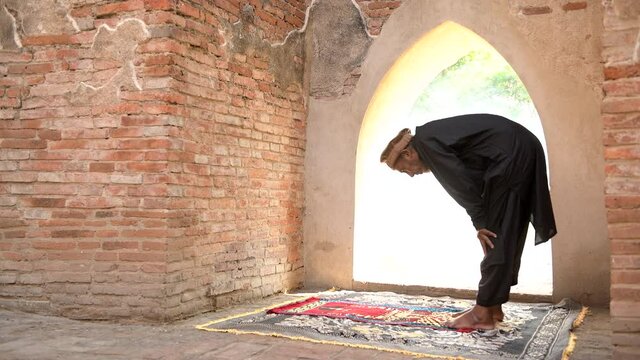 Muslim men praying at an old mosque in Ayutthaya, Thailand