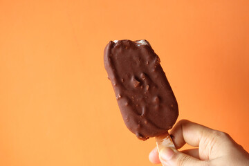 women hand holding chocolate ice cream with copy space 