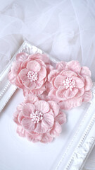 Artificial flowers made out of fabric in beautiful pastel pink color