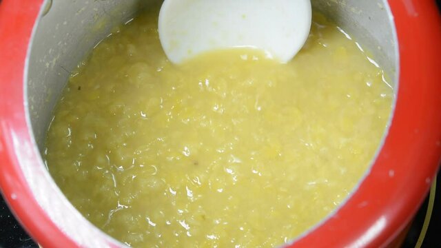 Cooking split pigeon peas in a pressure cooker. They are also called as Toor Daal in India.