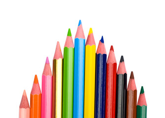 Top arrow shape made with some different colored wood pencil crayons on a white background