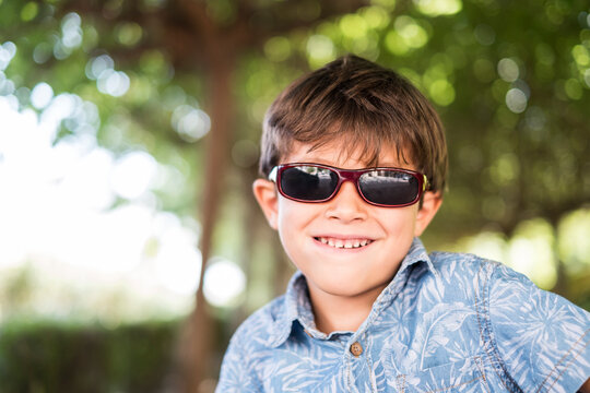 Cool boy portrait with sunglasses in outdoors image looking at camera