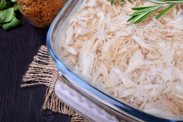 Holodets chicken meat jelly in a glass dish and a jar of mustard