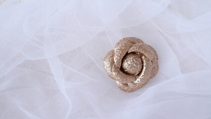 Artificial rose flower made out of glitter gold fabric