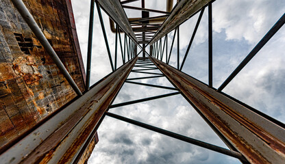 Fototapeta na wymiar Old metal tower extending to sky 