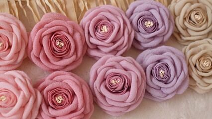 Artificial flowers made out of crepe or chiffon fabric in beautiful pastel colors