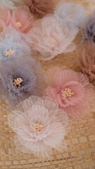 Artificial flower made out of tulle fabric in beautiful pastel colors