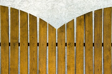 yellow fence boards on blurred background of plastered wall