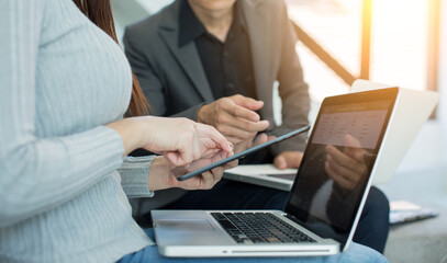 A business analyzing investment charts at workplace investment concept office with using a tablet computer 