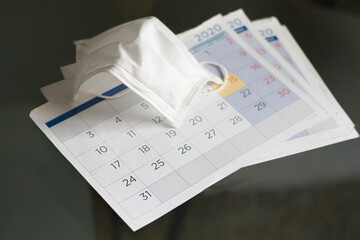 Fototapeta premium Calendar and mask. 2020 is a year marked by the coronavirus called covid 19