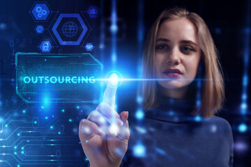 Business, Technology, Internet and network concept. Young businessman working on a virtual screen of the future and sees the inscription: Outsourcing