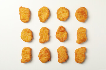 Flat lay with fried chicken nuggets on white background