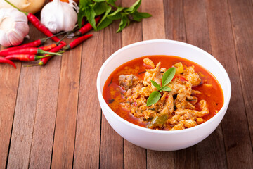 Thai curry red soup,Thailand tradition menu,boiled red curry with coconut milk and chicken on wood table